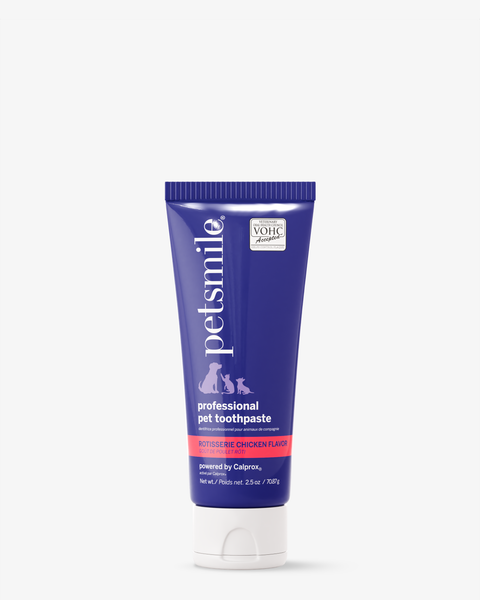 A tube of petsmile Professional Toothpaste Rotisserie Chicken with its blue and white design stands upright alongside the Professional Pet Toothbrush—ideal dental care for pets, thanks to its Calprox formula.