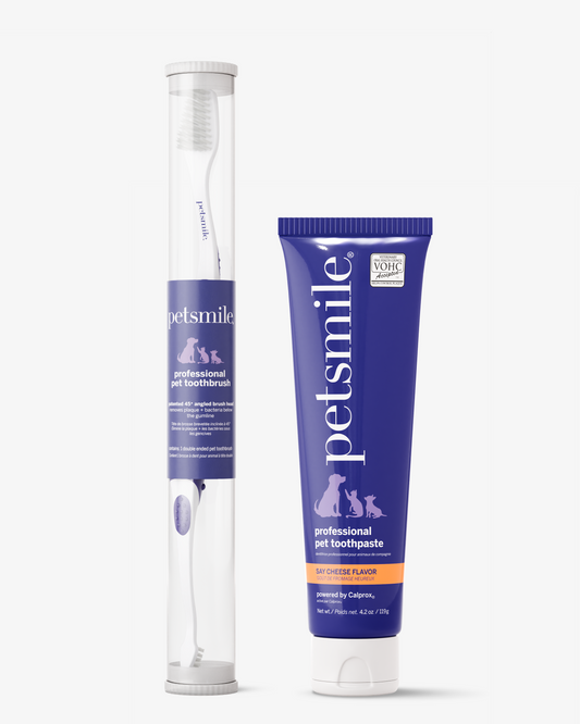 A white petsmile Professional Pet Toothbrush in a clear tube sits beside a purple tube of petsmile Professional Toothpaste Say Cheese Large, featuring pet silhouettes and the VOHC seal for veterinary oral health.